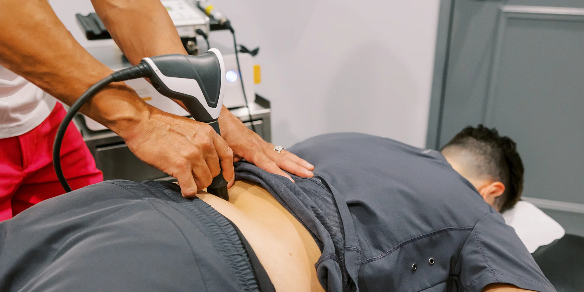Chiropractic Chandler AZ Patient Receiving Shockwave Therapy On Back